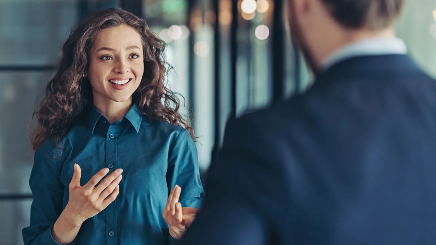 A woman is having an animated discussion with a colleague.